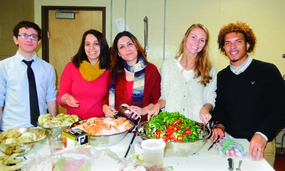 Jacob Kaufman, Sani Motamedi, Maryam Marzban, Jessica Fischer and Michael Bonilla prepare a Persian eggplant dish and Israeli salad for the Avi Schaefer dinner at URI Hillel. /URI Hillel